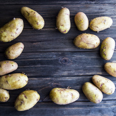 Young potatoes on a wooden table
