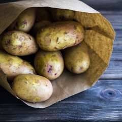 Young potatoes on a wooden table