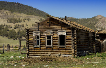 Old abandoned wooden house among the mountains