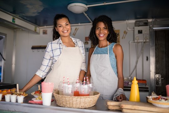 Portrait of waitress standing at counter