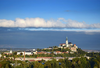 Frontal clouds above medieval castle with cathedral in Nitra, Slovakia, aerial view of cityscape ...