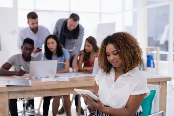 Female executive using digital tablet in the office