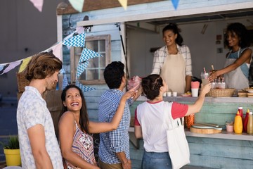 Waitress giving juice to customer at counter