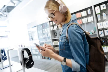 Printed kitchen splashbacks Music store Smart female student shopping for headphones