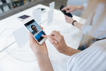 Close up of customers testing video calling on smartphone