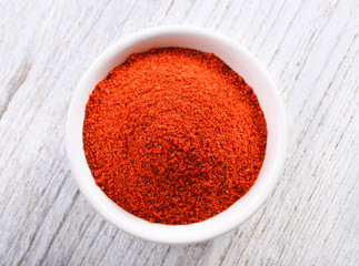 paprika powder on white wooden background