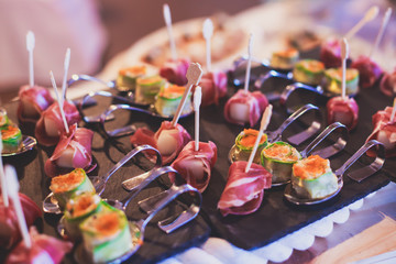 Decorated catering banquet table with different food appetizers assortment on a party
