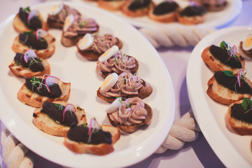 Decorated catering banquet table with different food appetizers assortment on a party
