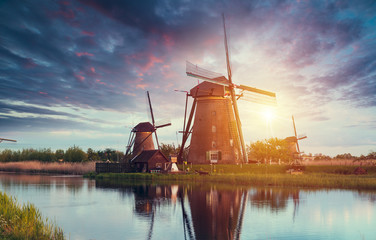 Fototapeta na wymiar sunshine behind Dutch windmill, Groningen, Netherlands