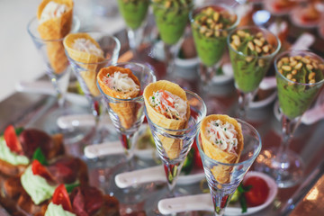 Beautifully decorated catering banquet table with different food snacks and appetizers on corporate christmas birthday party event or wedding celebration
