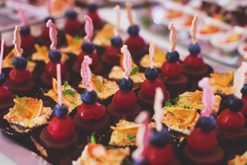 Decorated catering banquet table with different food appetizers assortment on a party
