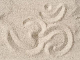 Fototapeta na wymiar Om symbol in sand
