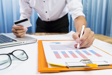 Successful project with business man working hard on financial charts in the office.