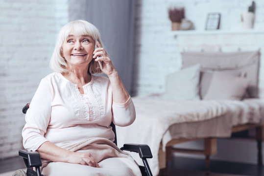 Delighted Disabled Lady Using Phone At Home