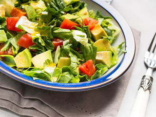 Healthy avocado spinach tomato salad. Gourmet dieting