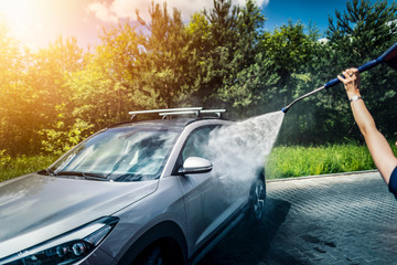 Obraz premium Manual car wash with pressurized water.