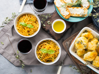 Lunch with curry pasta noodles in bowls and vegetables with turmeric