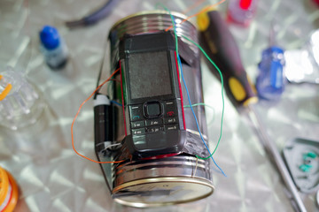 Homemade bomb with a cellphone timer, on a blurred background