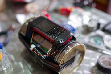 Homemade bomb with a cellphone timer, on a blurred background