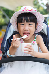 Asian Chinese little girl eating ice cream