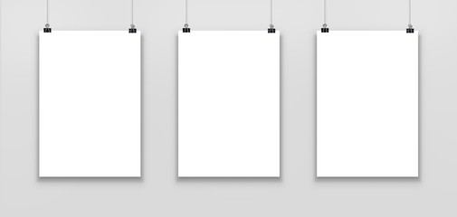 Three blank paper poster mockup isolated on a gray background. 
 - obrazy, fototapety, plakaty