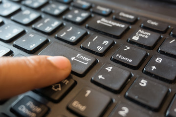 Fototapeta premium close up women finger point or click on enter button on the thai keyboard