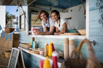 Portrait of waiter and waitress smiling - Powered by Adobe