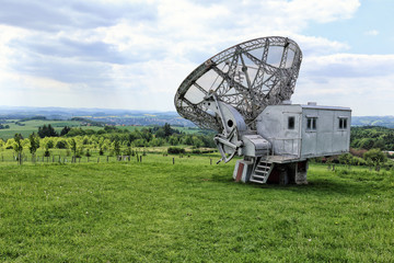 Giant radio telescope with silver control booth