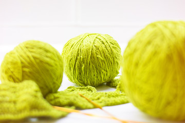 Woolen ball made of thread and knitting needles