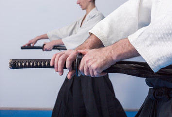 Hands holding the Katana. People on martial arts weapon practice
