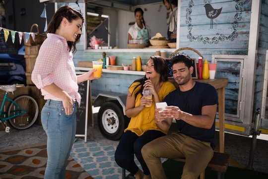 Friends interacting with each other in food truck van