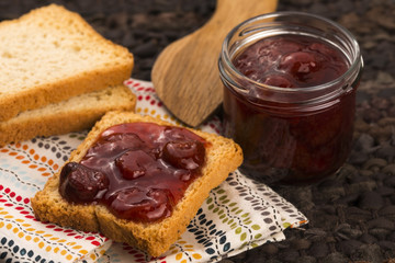 Breakfast of cherry jam on toast