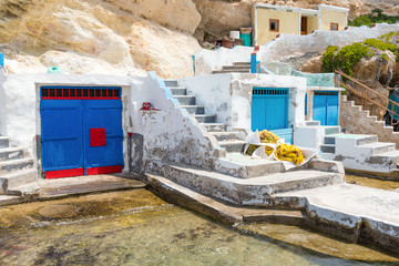 Blue boat house (sirmata) in Mandrakia village on the coast of Milos island, Cyclades, Greece © vivoo
