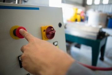 Hand pressing a control button