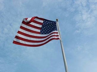 American flag on blue sky background
