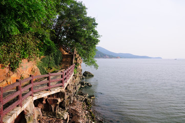 Fototapeta na wymiar A pathway attached to a cliff at The Three kingdoms scenic area in Wuxi China on Tai Lake.