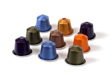 Multi-colored capsules with strong coffee in various angles on a white background