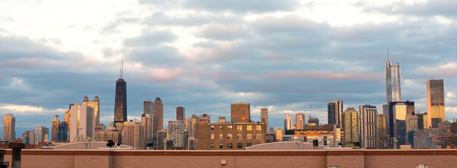 Striking panorama of the Chicago skyline at sunset, with an interesting cloudy sky above