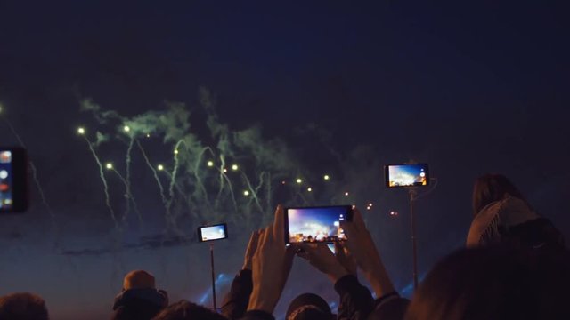 Peoples filming fireworks on a mobile phone. Slow motion