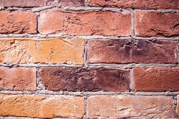 Brick red wall hand-laying. Vintage solid walls manual clutch of natural bricks. Construction of buildings and fortifications.