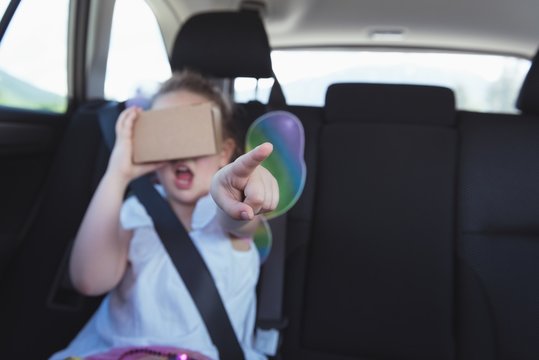 Girl pretending to use virtual reality headset