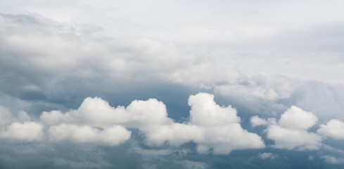 Beautiful white clouds against a backdrop of stormy clouds