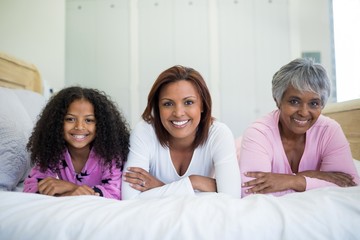 Happy family lying on bed in bed room