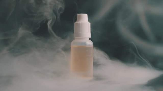 Cinemagraph Big Bottle Vape Juice Surrounded by a lot of Smoke Vapor in Loop