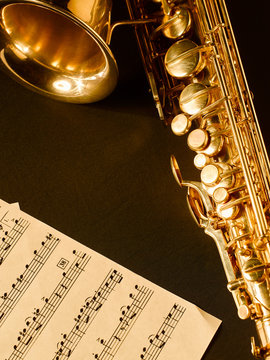 Golden saxophone on dark background.