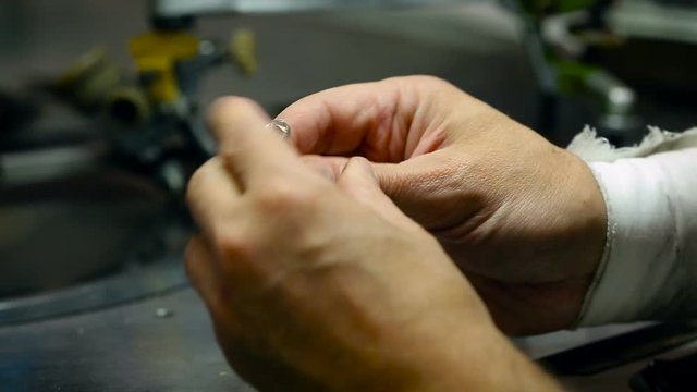 Jewellry Workshop. Diamond Cutter Working on Crystal. Man Putting Stone Into Metal Holder