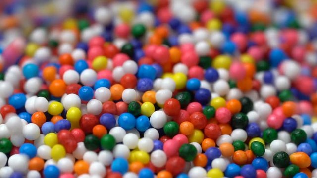 Colorful sprinkles sugar candy pouring down