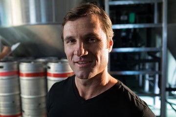Portrait of worker standing at warehouse