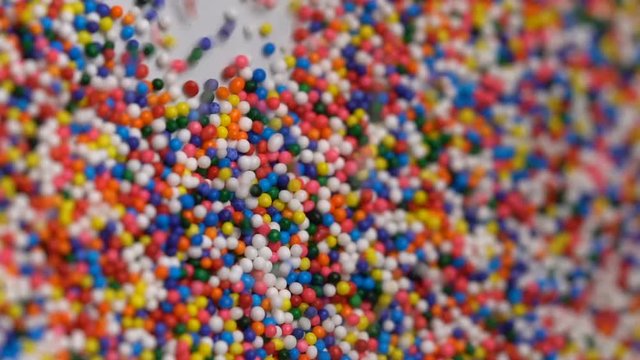 Colorful sprinkles sugar candy pouring down