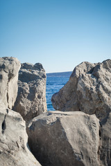 View of blue sea and sky through the big white stone